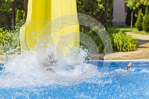 Children jump, swim and play in the pool on a beautiful sunny summer day.