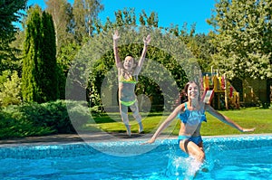 Children jump to swimming pool water and have fun, kids on family vacation