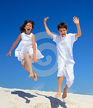 Children jumping on beach