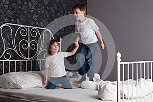 Children jumping on bed