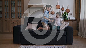 children jumping on the couch