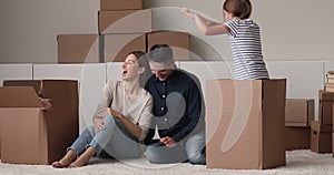 Children jumping out of boxes playing with parents at relocation