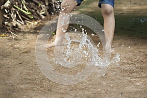 Children kick water.