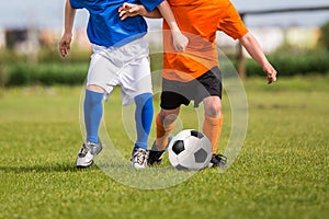 Children kicking soccer football ball