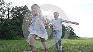 Children kid dream together run in the park. happy family people in the park concept. two sisters playing catch-up run