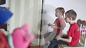 Children kids play video games console. boy and girl play online the games indoors