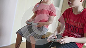 Children kids play video games console indoors. boy and girl play online the games