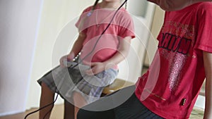 Children kids play video games indoors console. boy and girl play online the games