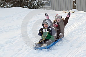 Children kids sledding toboggan sled snow winter