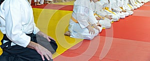 Children in kimono sitting in a line on tatami