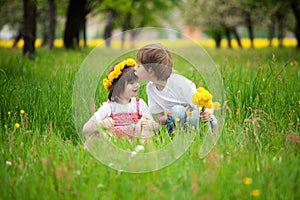 Children kissing in meadow