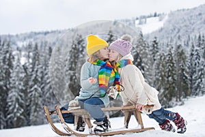 Children kissing. Outdoor kids little boy and girl kiss on winter outdoors.