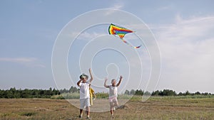 Children with kite, little friends play and have fun in meadow during summer holidays, concept of happiness
