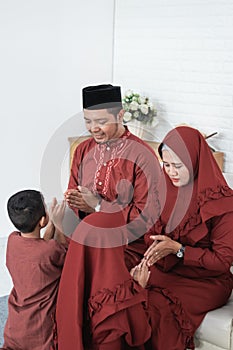 Children kneel bow to his parent for apologize