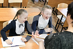 Children laugh at the school teacher.