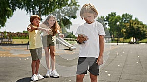 Children laughing from boy with mobile phone