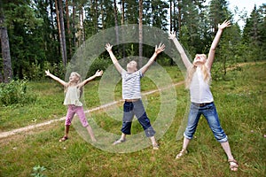 Children on lawn of forest and enjoy life in sports