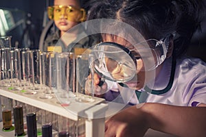 children leaning about chemistry in science examination laboratory