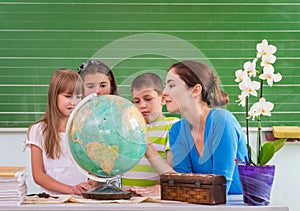 Children learn in school from the globe, Geography