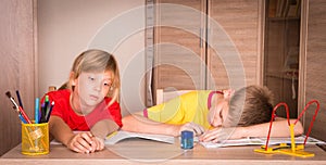 Children with learning difficulties. Tired boy and bored girl do