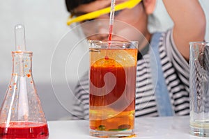 Children are learning and doing science experiments in the classroom. Little girl playing science experiment for home schooling.