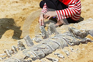 Children learning about, Excavating dinosaur fossils simulation