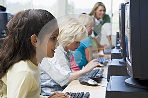 Children learning how to use computer