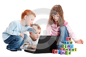 Children learning with kids letters and computer