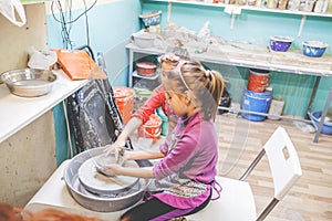 Children Learning New Skill At Pottery Workshop In Art Studio