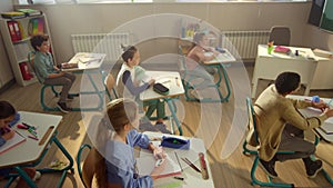 Children learning science in school class. Students having lesson in classroom