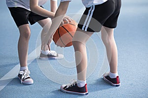 Children learning to dribble basketball