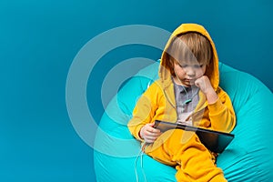Children leisure concept, digital technological childhood. Child kid boy watching laptop, computer, tablet. Listen to music with
