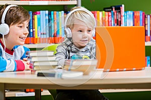 Children in a library listening to audio books