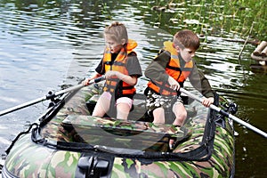 Children in life jackets swimming on boat