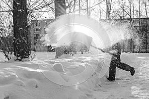 Children like to clean up the snow on a sunny day