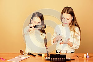 Children little girls choose cosmetics. Makeup store. Experimenting with style. Makeup courses. Makeup art. Explore