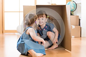 Children little girls playing inside box