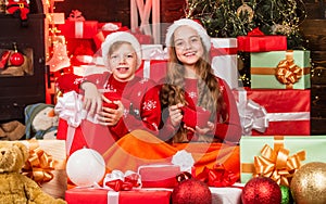 Children little happy girl and boy find gifts near christmas tree. Merry christmas. Discover beauty of winter. Hot cocoa