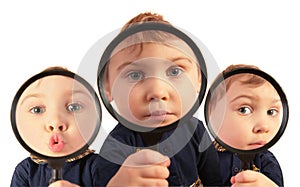 Children looking through magnifiers collage