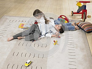 Children Lying On Rug At Home