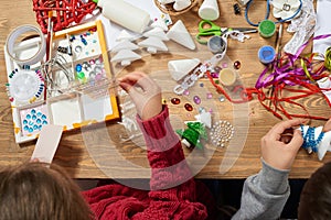 Children make crafts and toys, christmas tree and other. Painting watercolors. Top view. Artwork workplace with creative accessori