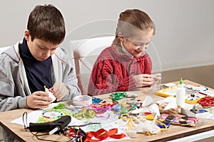 Children make crafts and toys, handmade concept. Artwork workplace with creative accessories.