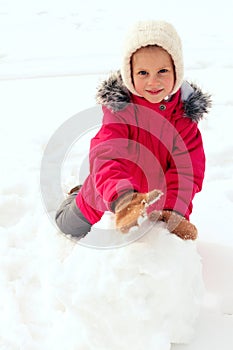 Children making big snowman