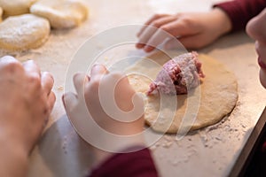 Children making traditional Russian pirozhky pastries