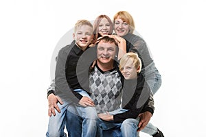 Children and mom hug happy dad, portrait of large adult family, isolated on white background