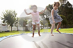 Children At Montessori School Having Fun On Outdoor Trampoline