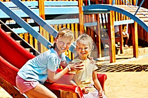 Children move out to slide in playground