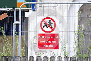 Children must not play on scaffolding at construction building site safety sign