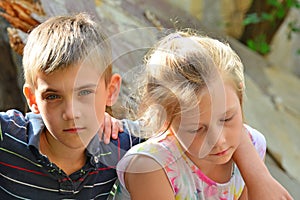 Children are near the ruined house, the concept of natural disaster, fire, and devastation.