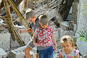 Children are near the ruined house, the concept of natural disaster, fire, and devastation.